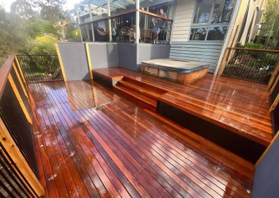 Freshly oiled multi-level hardwood deck with steps and a spa