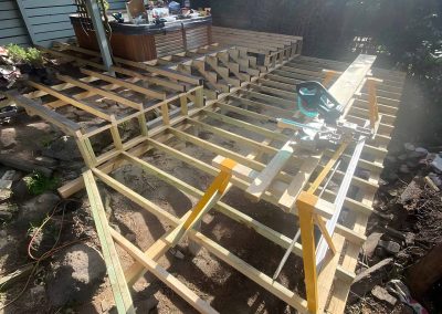 Treated pine deck subframe being built with a mitre saw on site