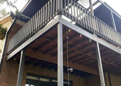 Elevated balcony with a grey timber balustrade and steel posts