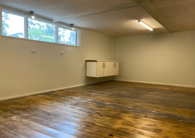 Finished room with a timber floor, cream walls and wall cupboards