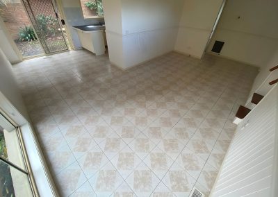 Living area with old beige floor tiles and white walls