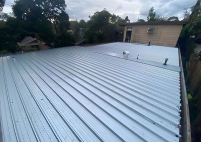 Finished corrugated metal roof on a single-storey house