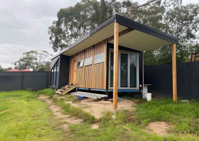 Backyard studio with vertical timber cladding and a skillion roof