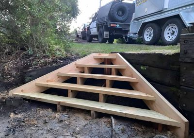 New treated pine steps against a sleeper retaining wall