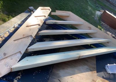 Treated pine stair stringers and treads being assembled