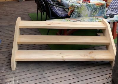 Small set of treated pine steps on a timber deck