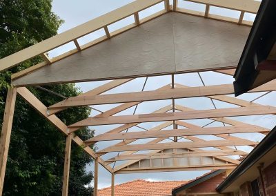 Gable pergola roof frame with rafters and battens, seen from below