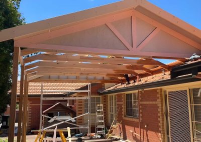 Gable pergola frame with a lined gable end over a brick courtyard