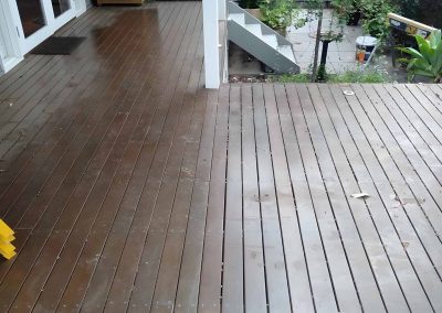 Dark-stained timber deck with steps down to a garden