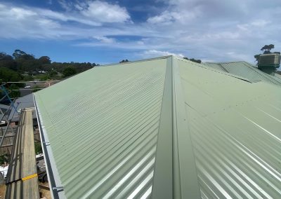 New green corrugated metal roof on a house extension
