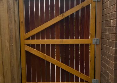Back of a stained timber side gate with a Z-brace frame