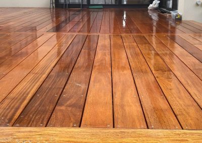 Freshly oiled hardwood deck leading to sliding doors