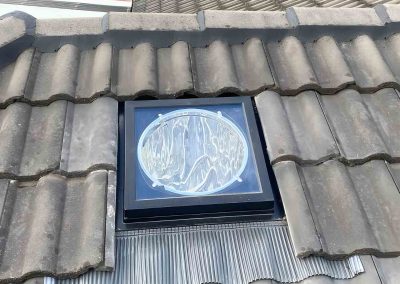 Skylight dome fitted into a concrete tile roof with new flashing