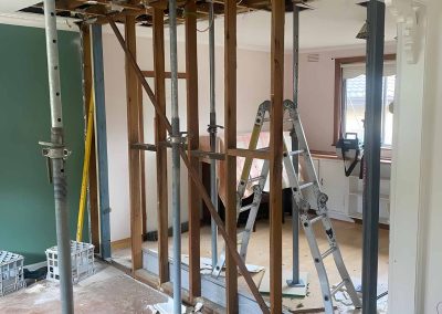 Wall opened up between rooms with steel props and new timber framing