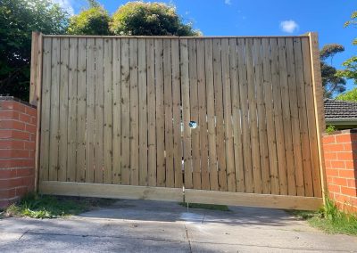 Treated pine double driveway gates between brick pillars