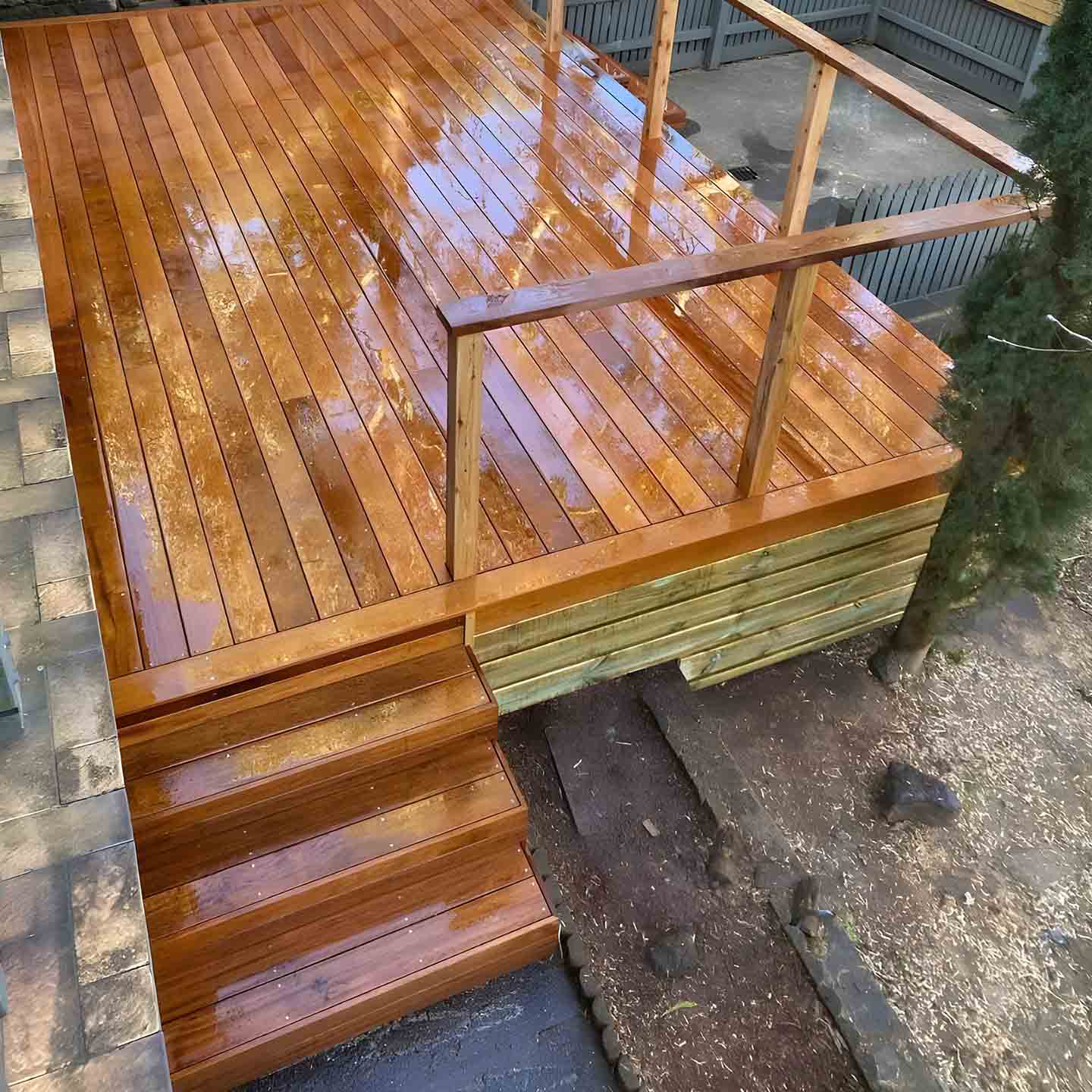 Freshly oiled hardwood deck with steps and a timber balustrade