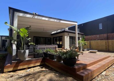 After: new multi-level timber deck with steps and pot plants